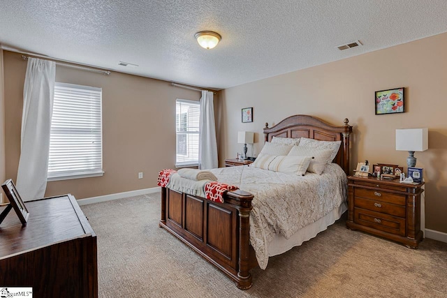 carpeted bedroom featuring a textured ceiling