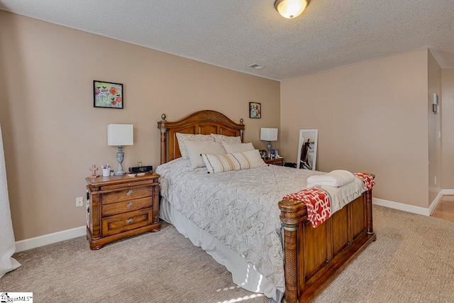 carpeted bedroom featuring a textured ceiling