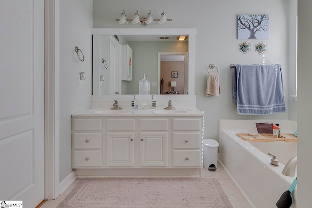 bathroom with tile patterned floors, vanity, and a tub to relax in