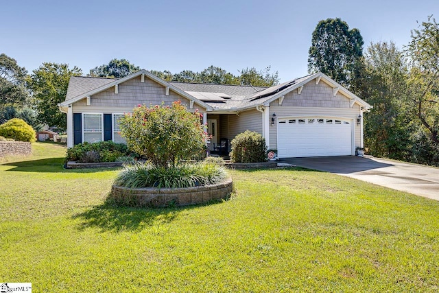 view of front of home with a front yard, solar panels, and a garage