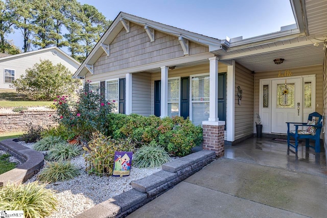 view of exterior entry with a porch