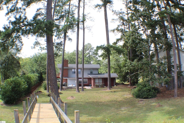 rear view of property with a lawn