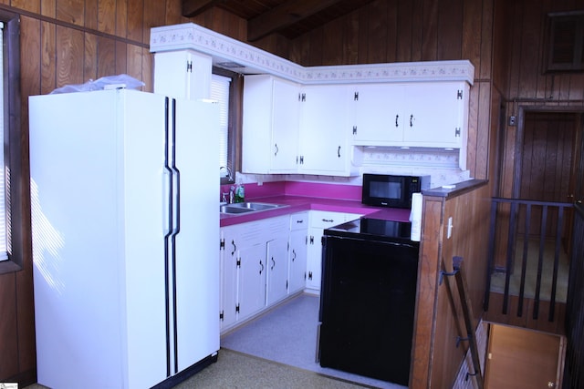 kitchen featuring white cabinets, sink, beamed ceiling, and black appliances