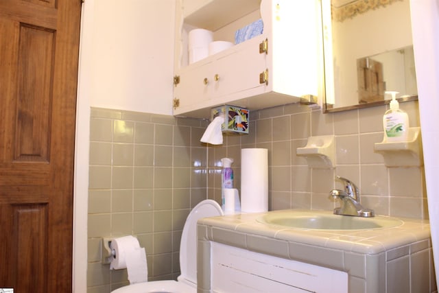 bathroom with decorative backsplash, vanity, and toilet