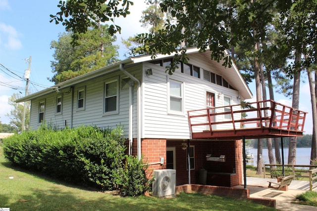 back of property featuring ac unit, a yard, and a wooden deck