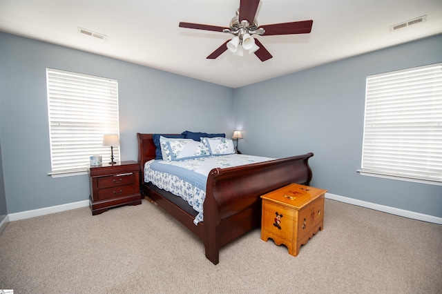 bedroom featuring ceiling fan and light carpet