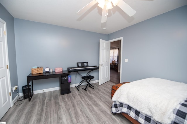 bedroom with hardwood / wood-style floors and ceiling fan