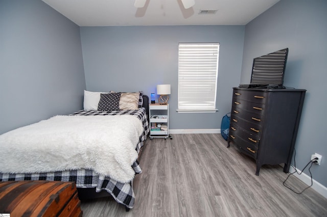 bedroom featuring light hardwood / wood-style floors and ceiling fan