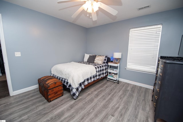 bedroom with ceiling fan and hardwood / wood-style floors