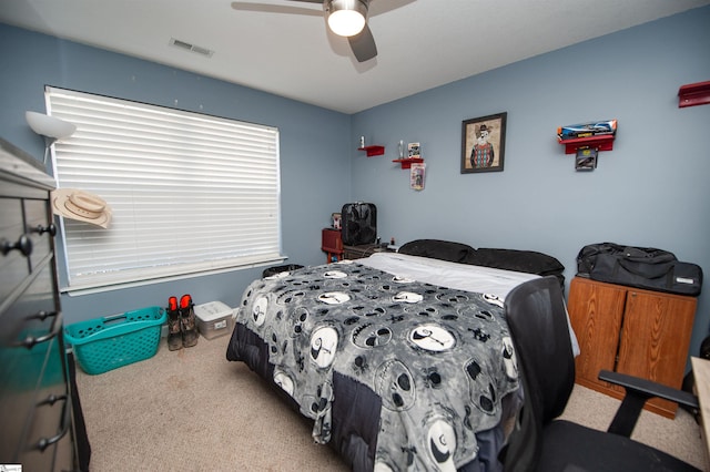 bedroom with light carpet and ceiling fan