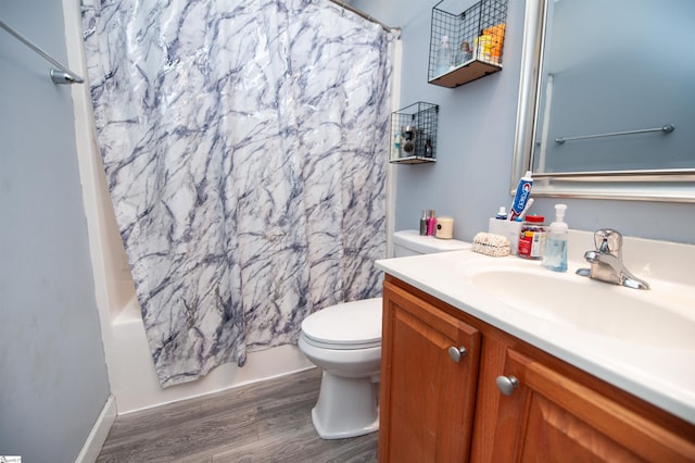 full bathroom with hardwood / wood-style floors, vanity, toilet, and shower / bath combination with curtain