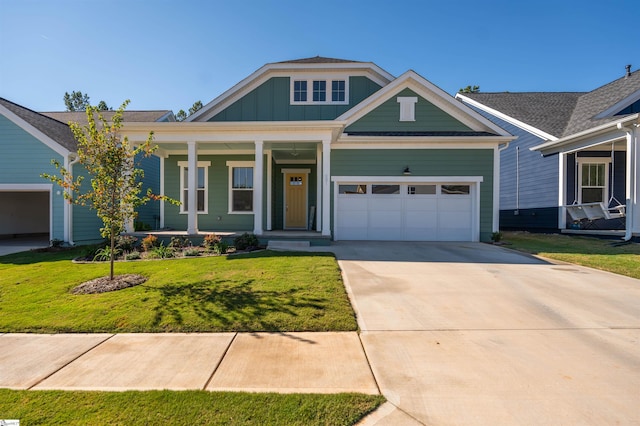 view of front of property with a porch, a garage, and a front yard