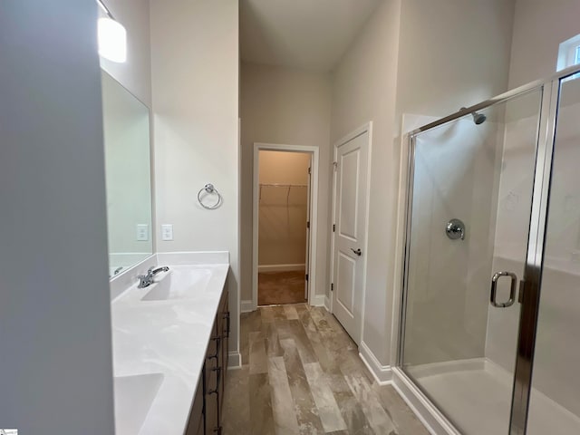 bathroom with vanity, wood-type flooring, and walk in shower