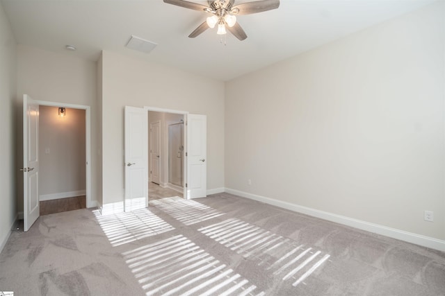 unfurnished bedroom featuring light carpet and ceiling fan