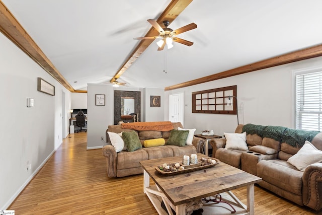 living room featuring ceiling fan, lofted ceiling with beams, and light wood-type flooring