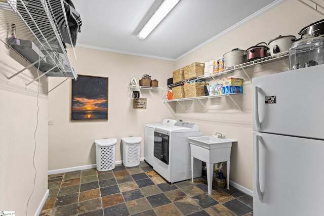 clothes washing area featuring separate washer and dryer and crown molding