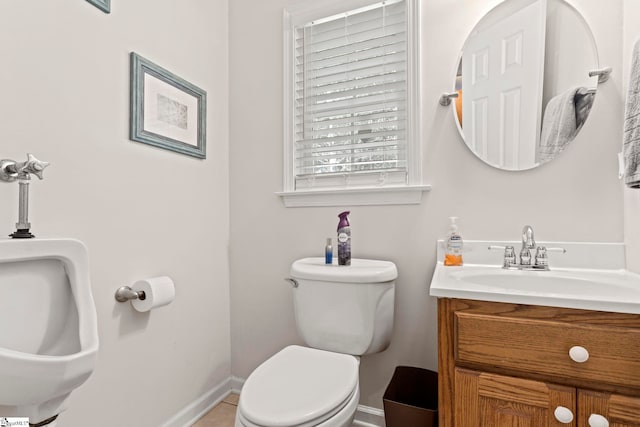 bathroom with tile patterned floors, vanity, and toilet