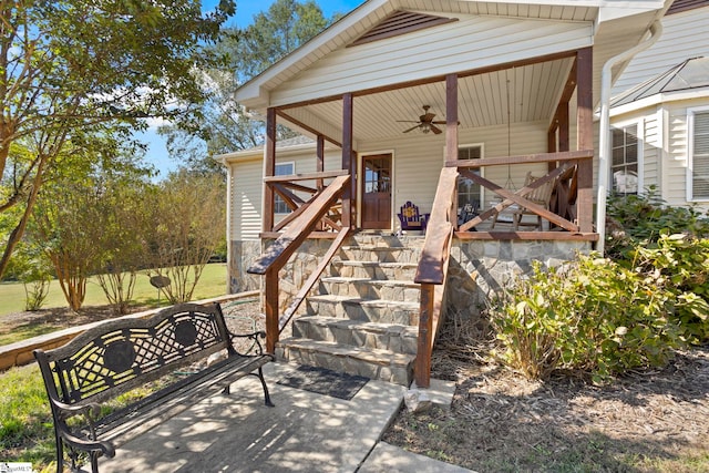 view of exterior entry featuring ceiling fan and a porch