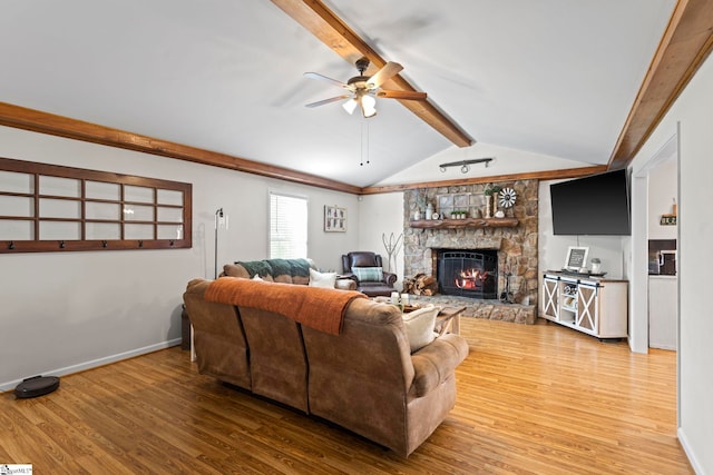 living room featuring ceiling fan, a fireplace, lofted ceiling with beams, and hardwood / wood-style flooring