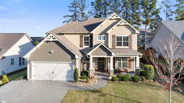 craftsman house featuring covered porch and a front lawn