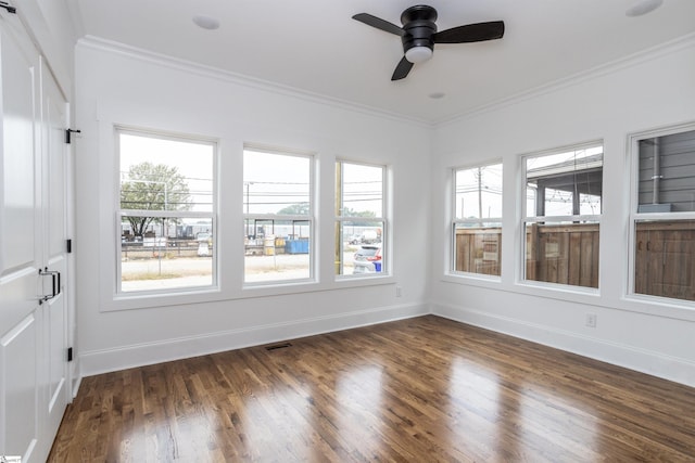 unfurnished sunroom featuring ceiling fan