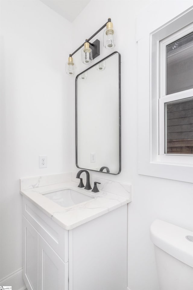 bathroom with vanity and toilet