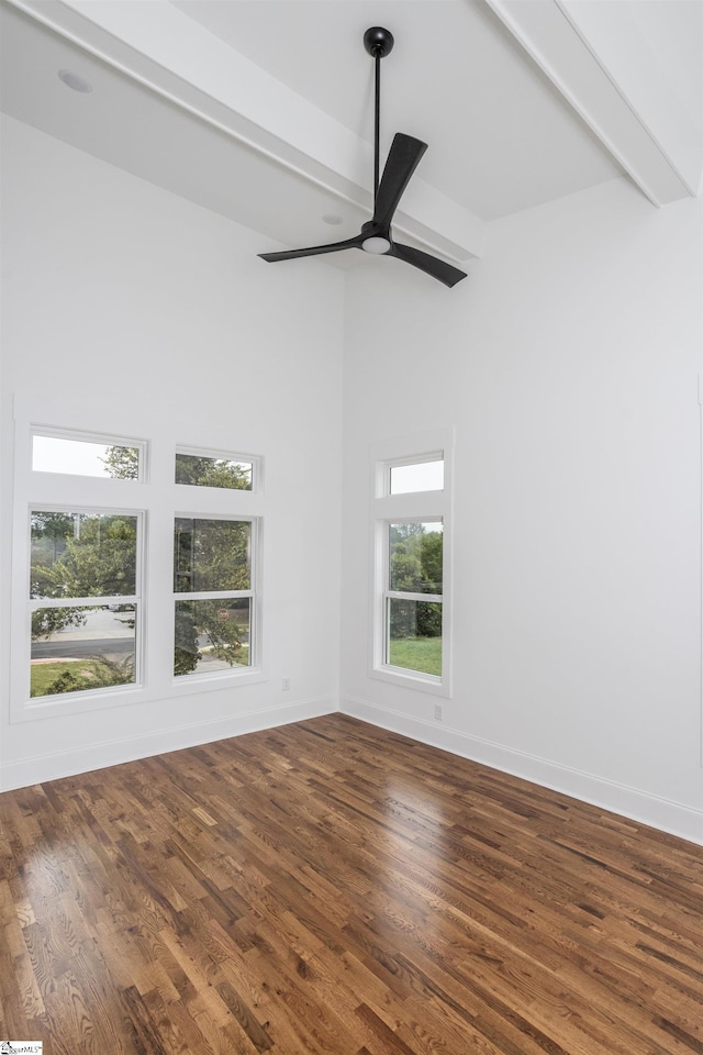 unfurnished room with hardwood / wood-style flooring, ceiling fan, a healthy amount of sunlight, and beam ceiling