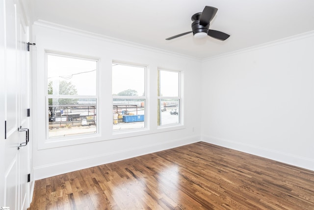 spare room with crown molding, dark hardwood / wood-style flooring, and ceiling fan