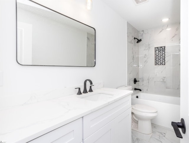 full bathroom with toilet, vanity, and tiled shower / bath