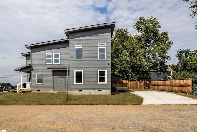 rear view of property with a lawn