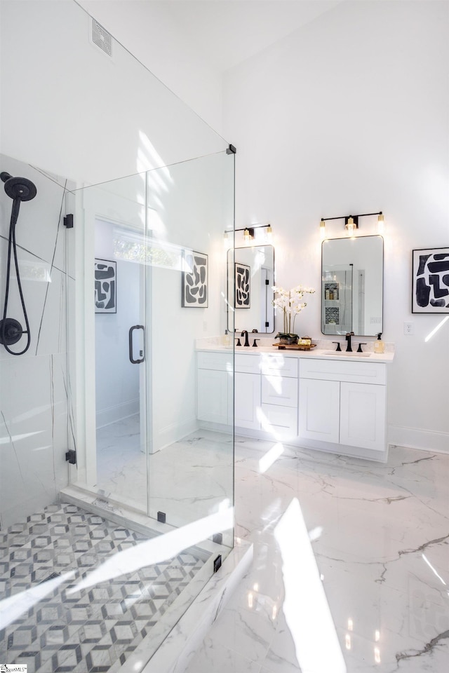 bathroom featuring vanity and a shower with shower door