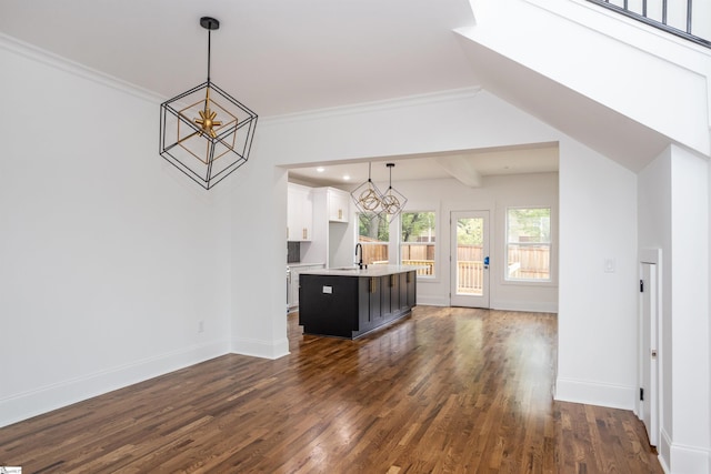 unfurnished living room featuring dark hardwood / wood-style flooring, crown molding, and a notable chandelier