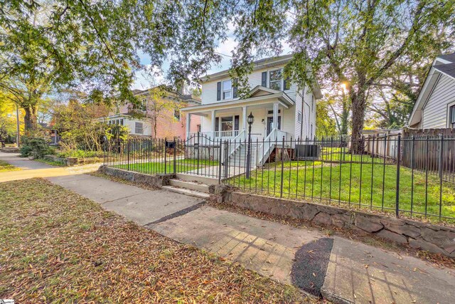 view of front of home with a porch, central AC, and a front lawn