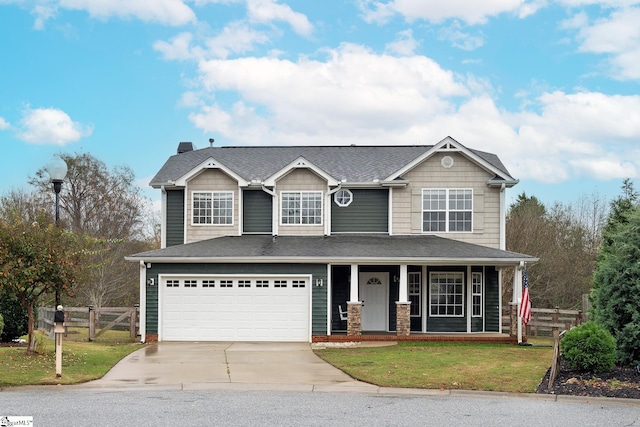 view of front of house with a front lawn, covered porch, and a garage