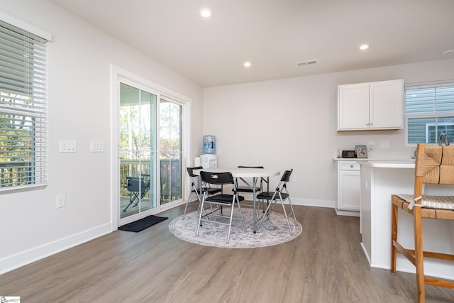 dining room featuring plenty of natural light and light wood-type flooring