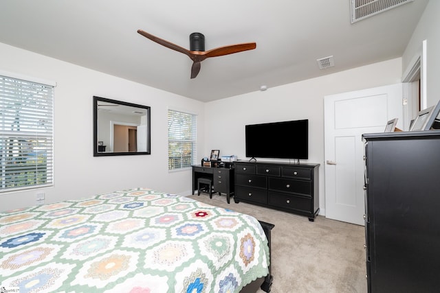 bedroom with ceiling fan and light carpet