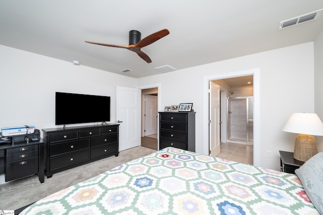 tiled bedroom with ceiling fan and connected bathroom