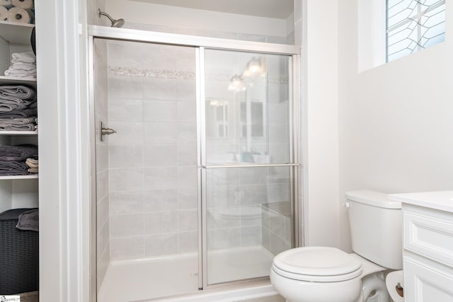 bathroom with vanity, toilet, and walk in shower