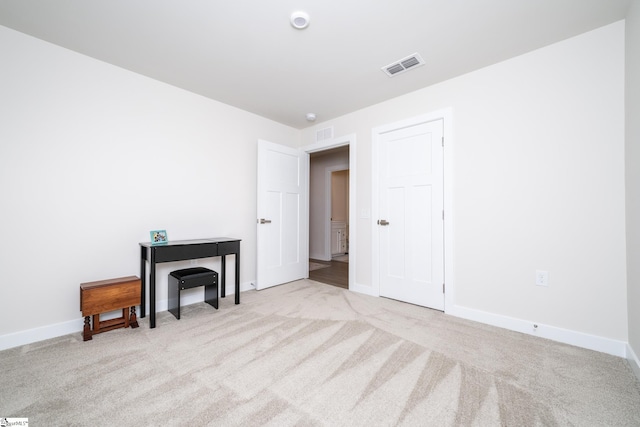 spare room with light colored carpet