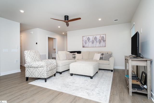 living room featuring ceiling fan and light wood-type flooring