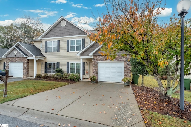 view of front of home with a garage and a front lawn