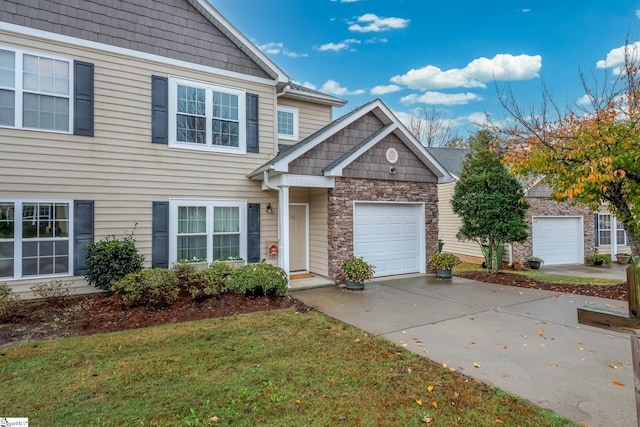 view of front of home with a garage and a front lawn