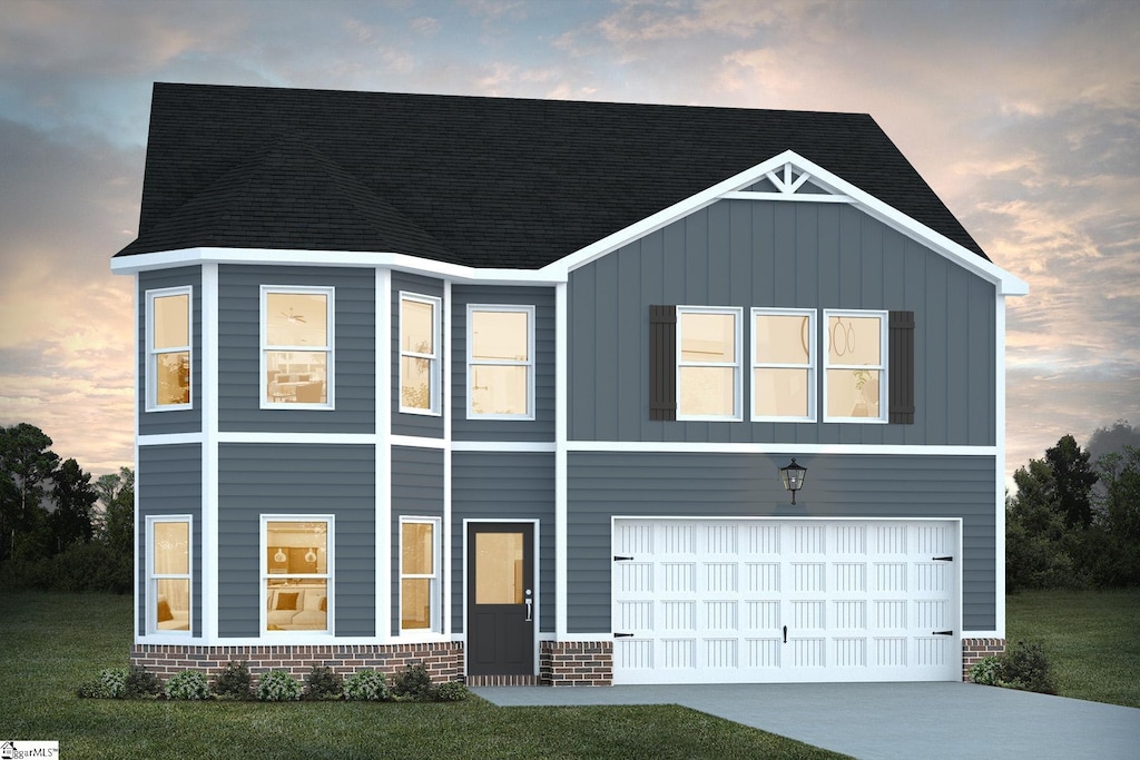 view of front of house featuring a yard and a garage