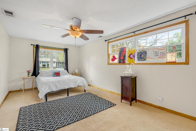 bedroom with ceiling fan and light carpet