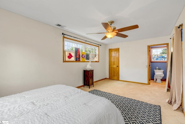 bedroom featuring multiple windows, ceiling fan, and light carpet