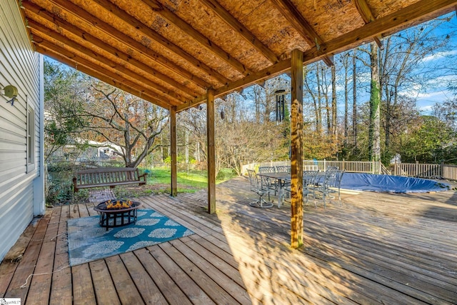 wooden terrace featuring an outdoor fire pit