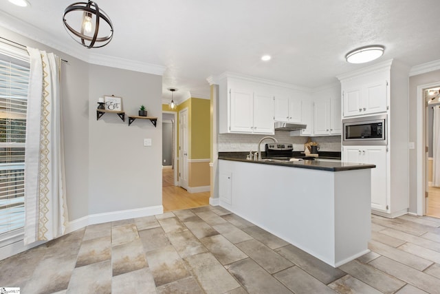 kitchen featuring white cabinets, appliances with stainless steel finishes, hanging light fixtures, and crown molding