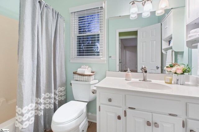 bathroom with tile patterned flooring, vanity, and toilet