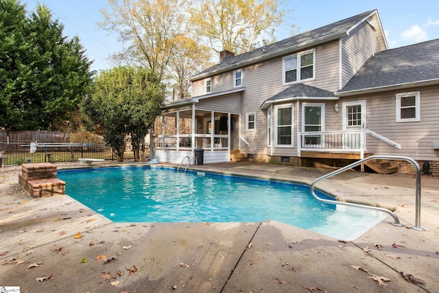 view of pool with a sunroom, a diving board, and a patio area