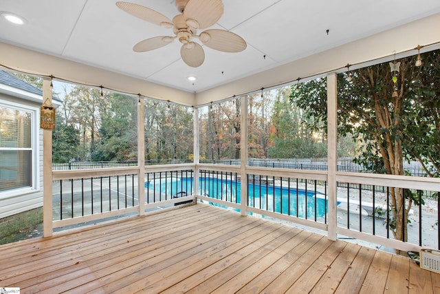 unfurnished sunroom featuring ceiling fan and plenty of natural light